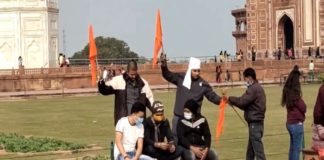 waving saffron flags at Taj