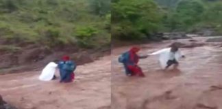 Health workers cross the river to deliver the vaccine