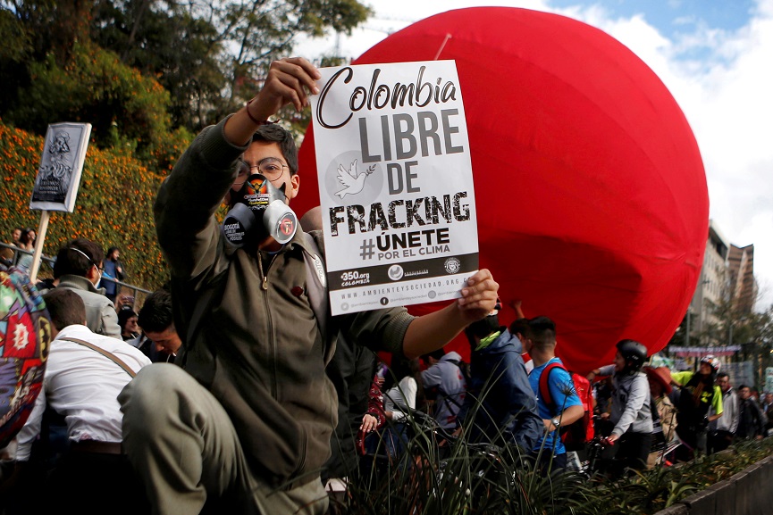 An activist holds a poster 