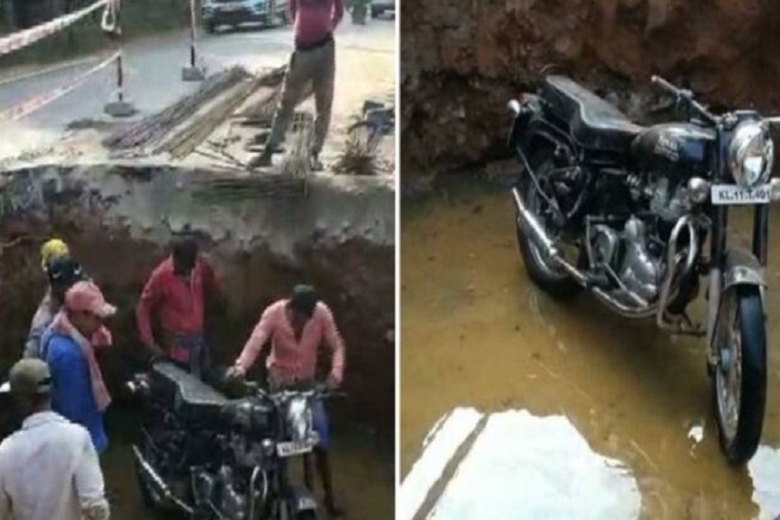 Biker falls into pit Biker falls into pit