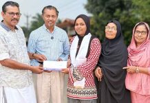Safana Cheriyakath receiving flight ticket from PCWF officials to attend an IMUN conference in Istanbul