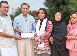 Safana Cheriyakath receiving flight ticket from PCWF officials to attend an IMUN conference in Istanbul