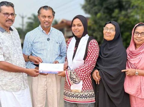 Safana Cheriyakath receiving flight ticket from PCWF officials to attend an IMUN conference in Istanbul