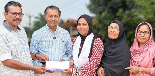Safana Cheriyakath receiving flight ticket from PCWF officials to attend an IMUN conference in Istanbul