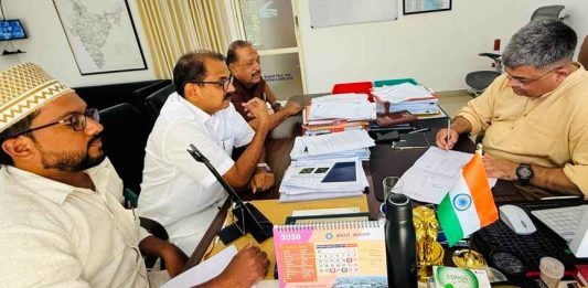 KP Noushad Ali discusses the Ponnani Foot Overbridge design change with NHAI officials, accompanied by Muhammed Rashid Hudavi and A.M. Samad.